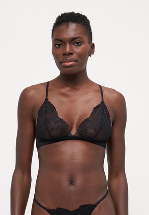 Black lace bralette featuring a floral pattern, triangular shape, adjustable straps, and a scalloped edge design. Soft, sheer texture.