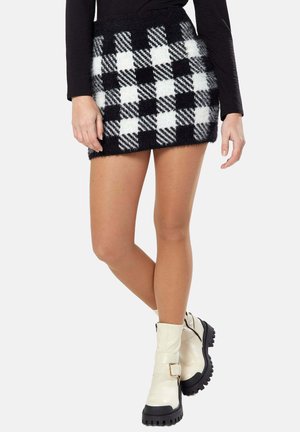 Black and white checkered knit skirt with a textured, fuzzy finish. Mini length with a fitted waistband and flared shape.