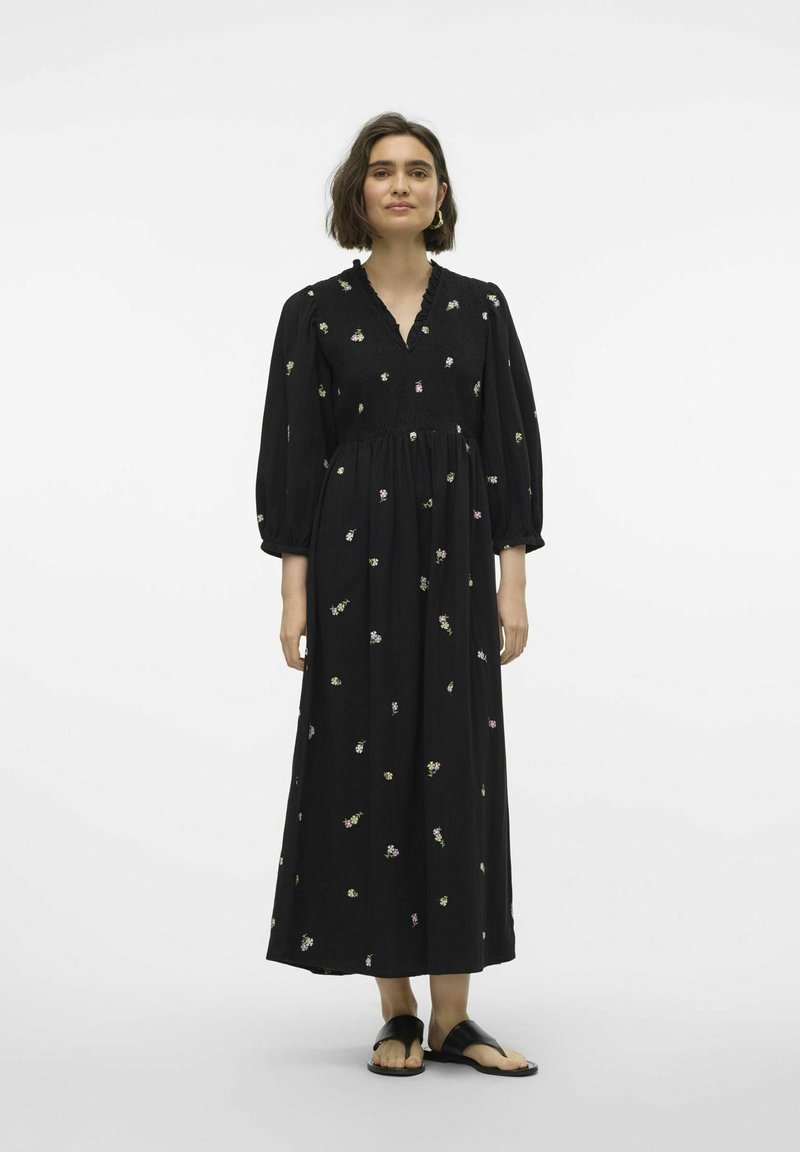 Schwarzes langes Kleid mit V-Ausschnitt, Puffärmeln und floralem Stickerei in verschiedenen Farben. Fließende Silhouette und leichtes Material.