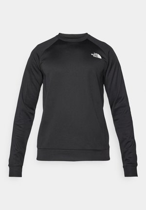 Svart långärmad sweatshirt i mjukt tyg. Har en rund halsringning, raglanärmar och en liten vit logotyp på bröstet.