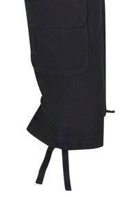 Svart cargo-bukser med en sidelomme, mansjettbindinger på kanten og et mykt, teksturert stoff for komfort.