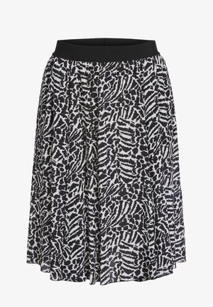 Jupe imprimé animal noir et blanc avec des plis souples et une ceinture élastique noire unie.