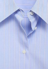 Light blue dress shirt with vertical white stripes. Features a classic collar and button closure, showcasing a smooth fabric texture.