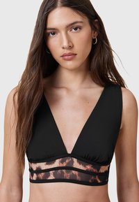 Top in bikini nero con scollatura a V profonda, spalline larghe e un pannello in rete con stampa leopardata in vita. Tessuto morbido con leggera lucentezza.