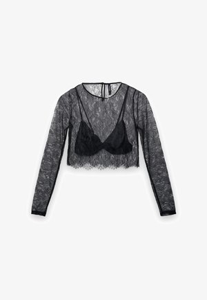 Schwarzes, langärmliges, kurzes Spitzenoberteil mit halbtransparentem Design, darunter ein schwarzes, blickdichtes Bustier, strukturierter Blumenmuster und rundem Ausschnitt.