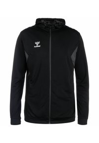 Zwarte hoodie met rits, voorzien van een textuur op het lichaam, gaasaccenten en Hummel-logo op de linkerborst. Reflecterende details op de mouwen.
