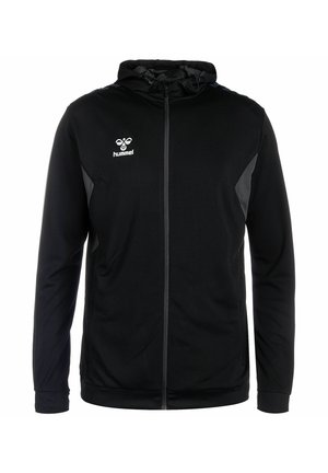 Schwarze Kapuzenjacke mit Reißverschluss, mit einer strukturierten Oberfläche, Netz-Einsätzen und Hummel-Logo auf der linken Brust. Reflektierende Details an den Ärmeln.