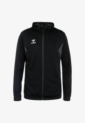 Schwarze Kapuzenjacke mit Reißverschluss, mit einer strukturierten Oberfläche, Netz-Einsätzen und Hummel-Logo auf der linken Brust. Reflektierende Details an den Ärmeln.