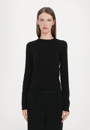 Langermet svart topp laget av mykt stoff med rund hals og sømløse mansjetter, med en tettsittende silhuett og minimalistisk design.