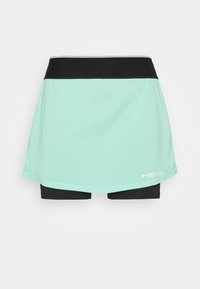 Una falda deportiva de color verde menta con pantalones cortos negros por debajo, que presenta una cinturilla negra y un pequeño logo blanco en la esquina inferior derecha.