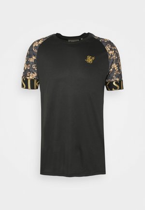 Czarna koszulka z wzorzystymi rękawami zdobionymi złotymi akcentami. Z przodu znajduje się małe logo w złotym kolorze; rękawy ozdobione są misternymi wzorami.