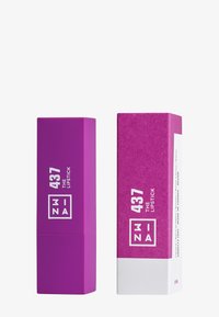 Tube de rouge à lèvres violet avec une finition mate, présentant un texte blanc. Accompagné d'une boîte violette assortie avec une surface texturée et des accents blancs.
