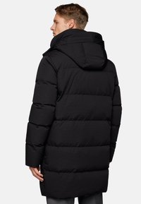 Black puffer jacket with horizontal quilting, hood, and a mid-length cut. Features a smooth fabric texture and slight sheen.