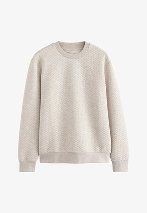 Jasno beżowy sweter z textured wzorem w zygzak, długie rękawy i okrągły dekolt. Miękka tkanina z ściągaczami na mankietach i dole.