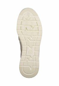 Semelle de chaussure en caoutchouc blanc avec des motifs en chevrons texturés et des reliefs pour l'adhérence. Bout arrondi et détails latéraux en matériau gris.