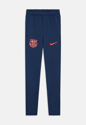 Pantalons de sport navy en tissu léger; dotés d'une taille élastique, de poches latérales et d'accents orange avec un logo de club et un logo de marque.