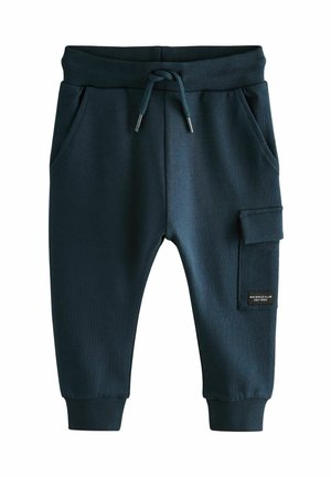 Pantalons de jogging bleu marine foncé en tissu doux, avec une taille à cordon de serrage, des poches latérales et une poche cargo avec une étiquette sur la jambe droite.