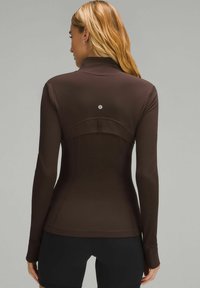 Brown long-sleeve athletic top featuring a high collar, fitted design, and a logo at the back. Made from smooth, stretchy material.