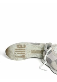 Zapatillas grises y blancas con un upper de ante texturizado y cordones planos blancos. La suela presenta un diseño de mapa y texto impreso.