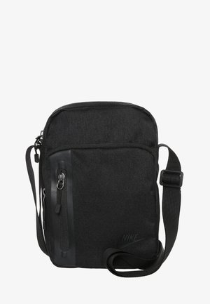 Black Nike crossbody bag with adjustable strap, front vertical zip pocket, and main zip compartment, made of textured fabric.