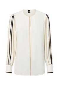 Weiße Bluse mit langen Ärmeln, mit beigen und schwarzen Streifen entlang der Ärmel und in der Mitte, runder Ausschnitt und mit Manschetten.