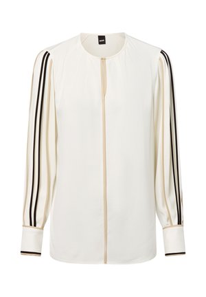 Weiße Bluse mit langen Ärmeln, mit beigen und schwarzen Streifen entlang der Ärmel und in der Mitte, runder Ausschnitt und mit Manschetten.