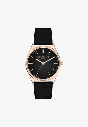 Sort ur med en rund, mat overflade, guld accenter og slanke timemarkører. Har et glat sort rem og et minimalistisk design.