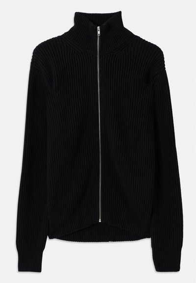Black ribbed sweater with a high collar and full-length zip. Features a textured fabric and slightly curved hem for a layered look.