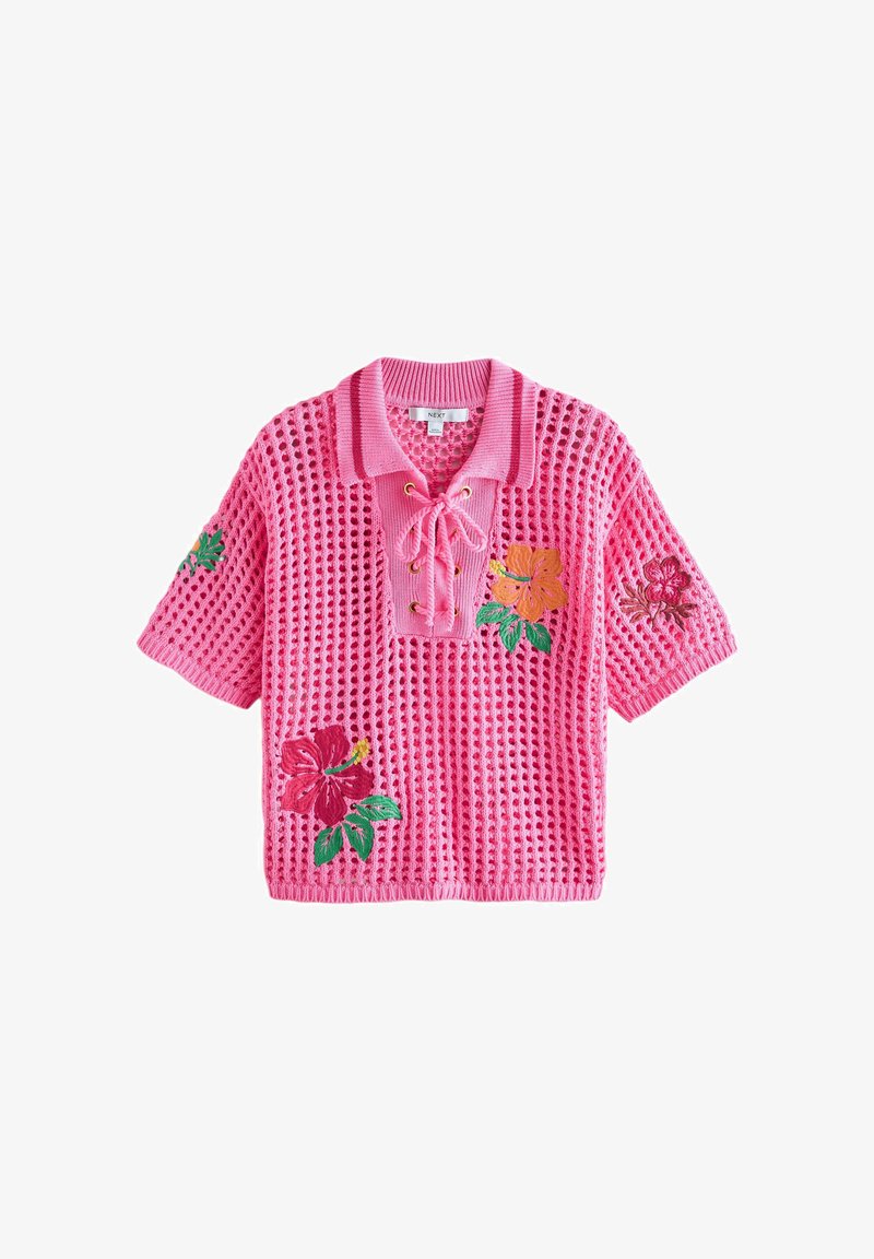 Pull rose en maille à manches courtes avec col à lacets et fleurs d’hibiscus rouges, orange et roses brodées sur le devant et les manches.