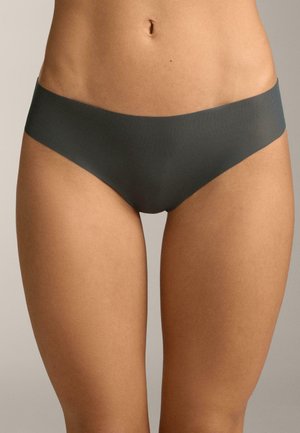 Donna che indossa biancheria intima senza cuciture di colore grigio scuro a vita bassa, che mostra il torso dalla vita fino alla parte superiore delle cosce su sfondo neutro.