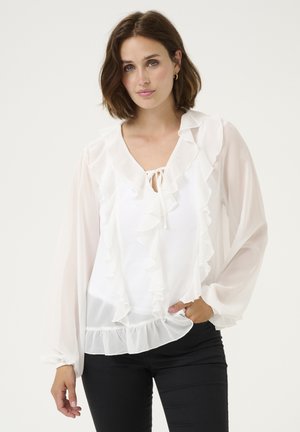 Bluză albă dintr-un material ușor, cu detalii fluturite la guler și mâneci, cu un tiv peplum și închidere prin legare.
