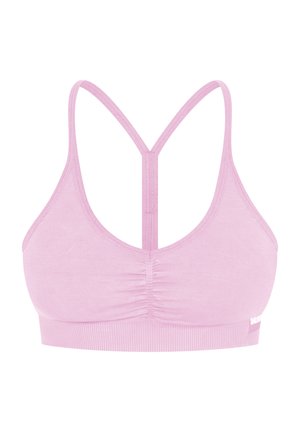 Top di sport rosa chiaro con scollatura a cuore e doppie spalline che formano un design incrociato sul retro. Tessuto morbido con una fascia testurizzata nella parte inferiore.