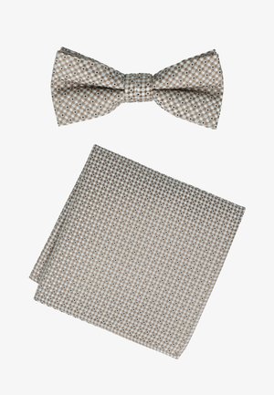 Beige bow tie and matching pocket square with a small checkered pattern featuring blue and dark brown accents.