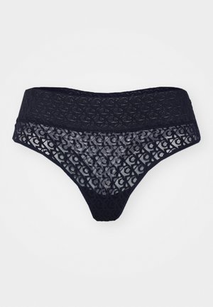 Lace thong in dark navy with a semi-transparent design, featuring a patterned waistband and delicate detailing along the edges.