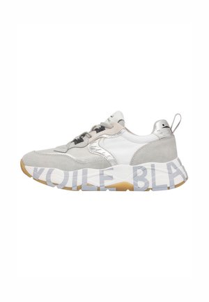 Light gray and white sneaker with suede and mesh panels, thick sole featuring large printed brand text, and pull tab at heel.