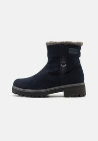 Bottes chevilles bleu marine en daim avec une doublure en fausse fourrure, bout arrondi et semelle en caoutchouc texturée avec des crampons profonds pour une meilleure adhérence.