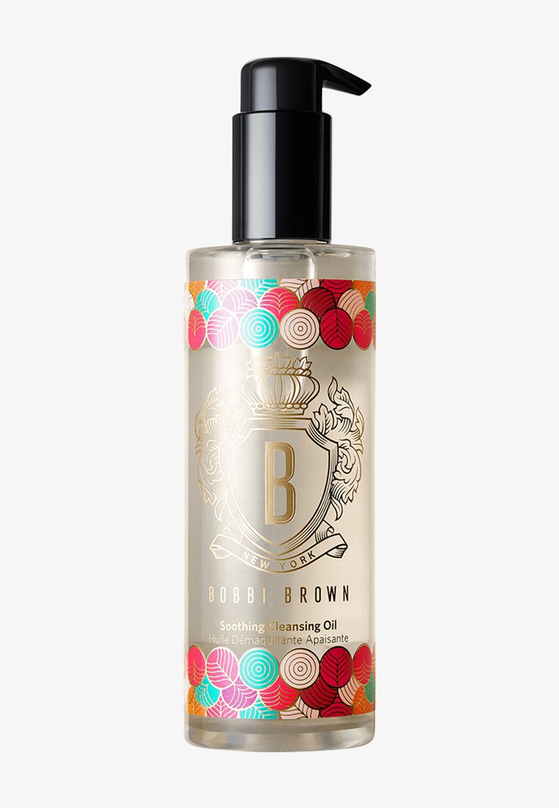 Clear plastic pump bottle of Bobbi Brown Soothing Cleansing Oil with colorful circular leaf patterns on top and bottom edges.