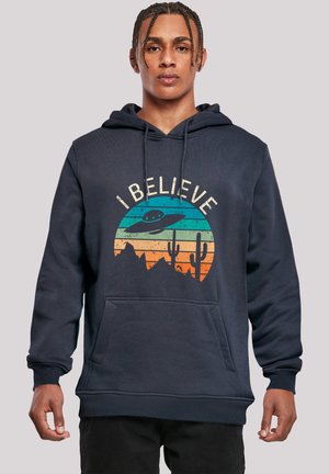 Navy blue hoodie featuring a graphic design of a UFO, mountains, and cacti in orange and teal, with a front kangaroo pocket.