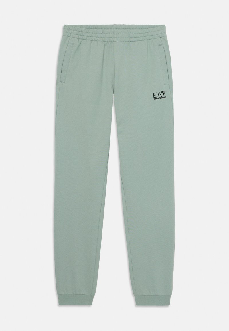 Light green sweatpants with an elastic waistband, two side pockets, and a small black logo on the left leg. Smooth texture, tapered fit.