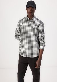 Tommy Jeans ISAAC CASUAL - Chinos - black