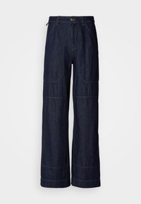 Vide ben denimbukser med kontraststing, som har frontlommer og glidelås. Mykt, solid stoff med en ren finish.