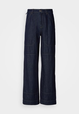 Wide-leg dark denim trousers with contrasting stitching, featuring front pockets and a zip fly. Soft, sturdy fabric with a clean finish.