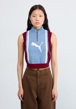 Knit sleeveless top with a zip collar, featuring light blue and burgundy sections and a white Puma logo, displayed against a neutral background.