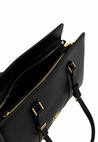 Black leather handbag with gold-tone hardware, featuring dual zip compartments and flat straps. Smooth texture with structured design.