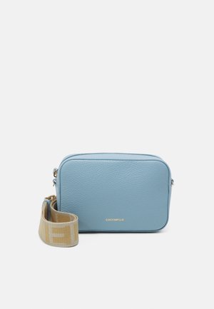 Sac bandoulière rectangulaire en cuir bleu clair avec sangle en tissu beige réglable et logo de marque doré sur le devant.