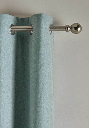Hellblauer Vorhang, der an einer silbernen Metallstange mit dekorativem Kugelknauf vor einer schlichten beigen Wand hängt.