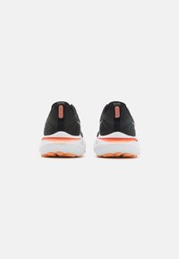 Black and orange athletic shoes featuring a mesh upper, padded collar, and white midsole with textured rubber outsole for traction.