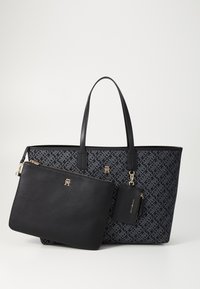 Tote bag with black and navy patterned fabric, large size, dual handles, accompanied by a small black pouch and cardholder with gold accents.