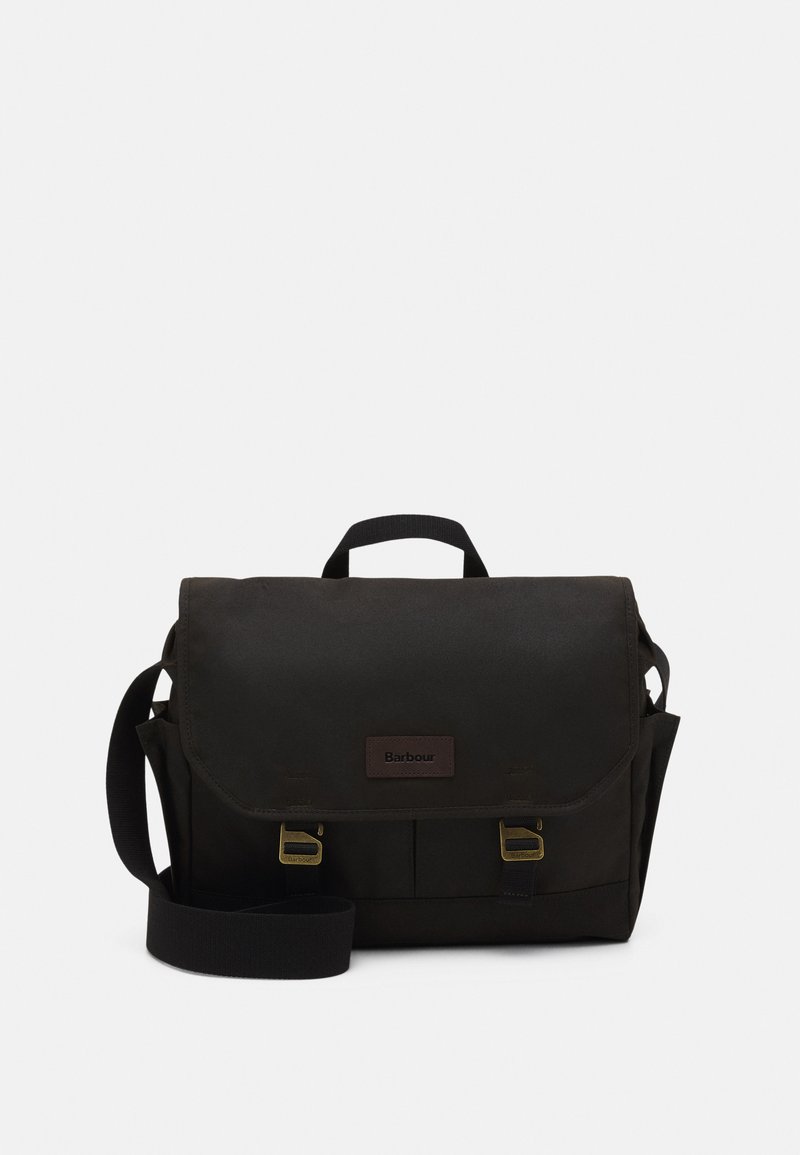Black Barbour shoulder bag with flap, two brass buckles, side pockets, top handle, and adjustable shoulder strap on white background.