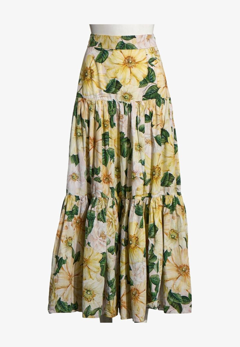 Longue jupe à volants avec grand imprimé floral jaune et feuilles vertes sur fond clair.